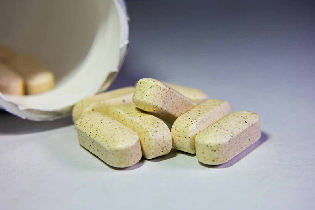 image of tablets coming out of a container