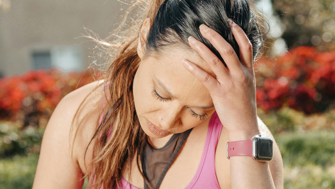 woman holding her head in pain