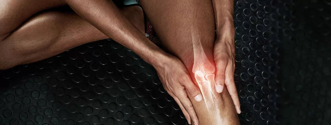 a man rubbing his leg muscles